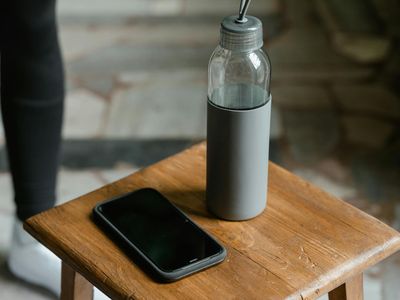Close up of a water bottle and sneakers.